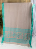 Stone beige cotton saree with turquoise blue details and multiple butas