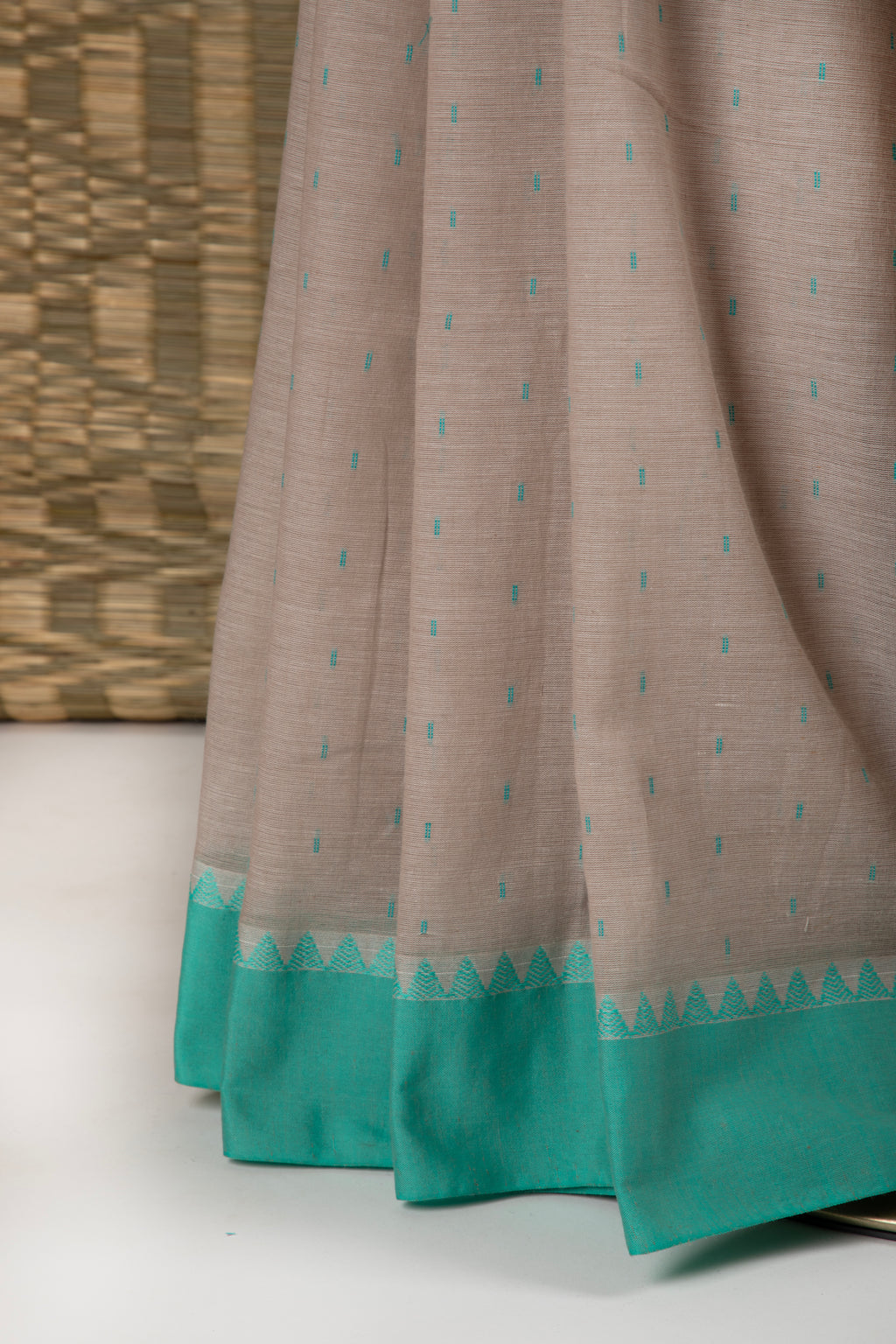 Stone beige cotton saree with turquoise blue details and multiple butas