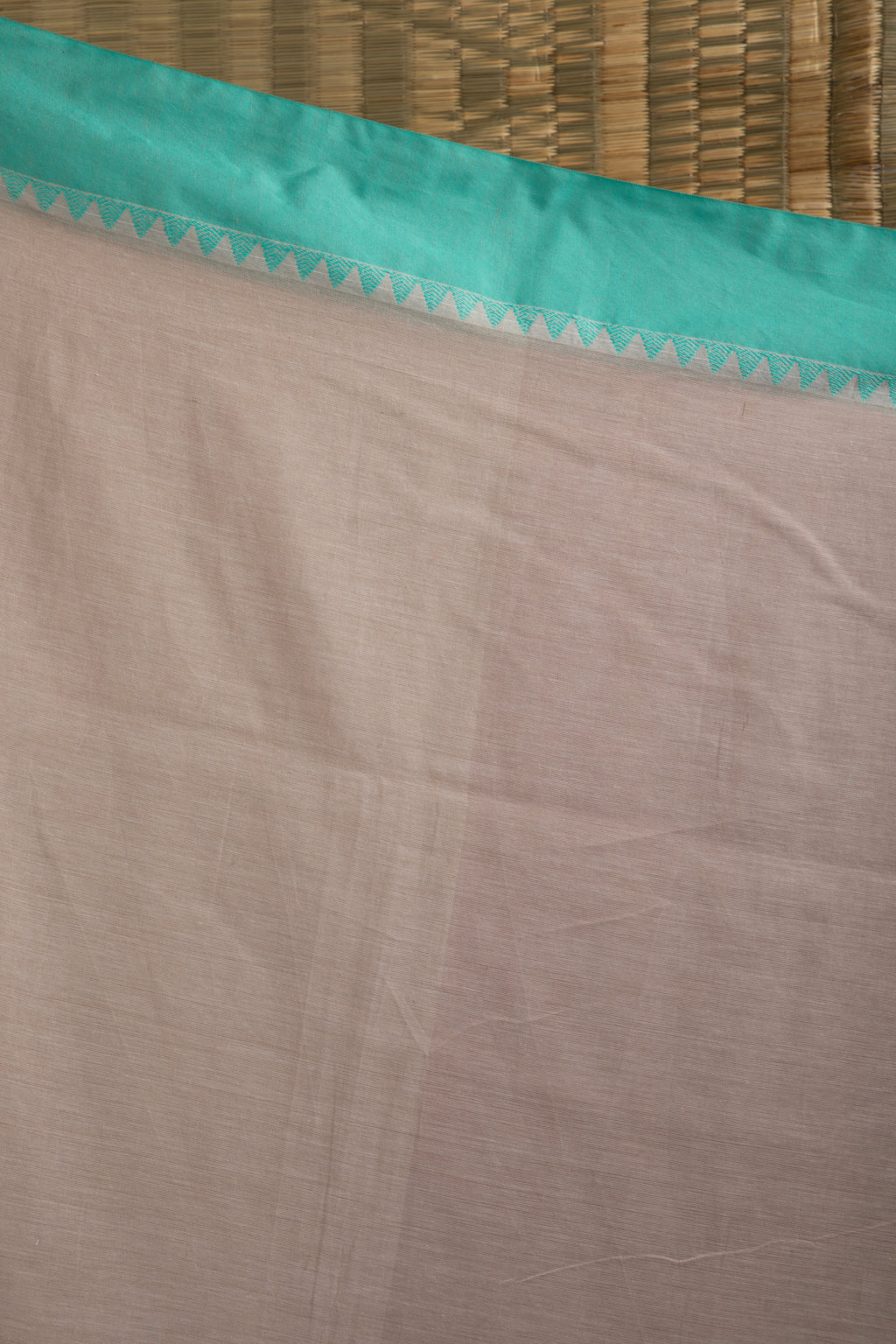 Stone beige cotton saree with turquoise blue details and multiple butas
