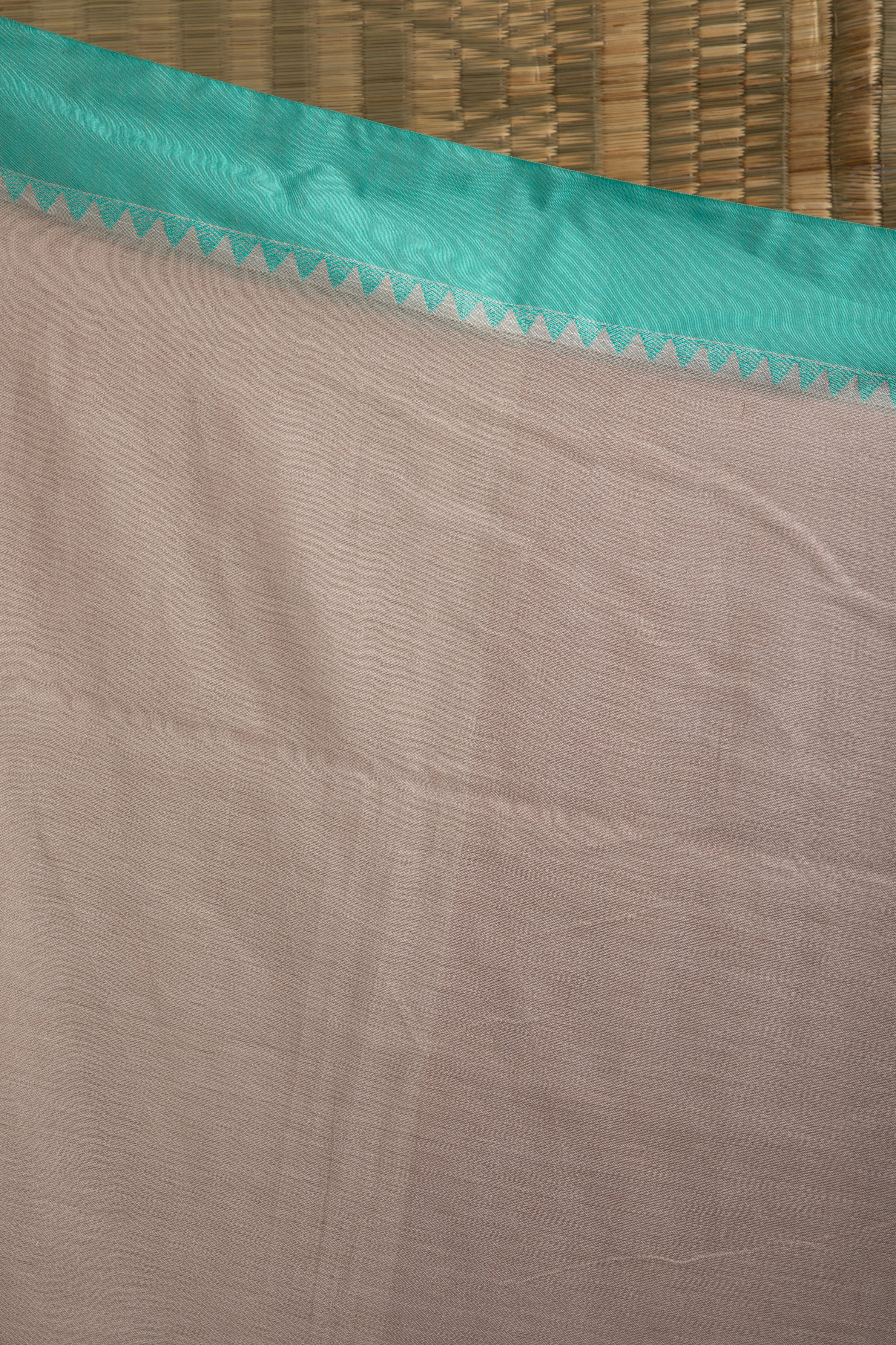 Stone beige cotton saree with turquoise blue details and multiple butas